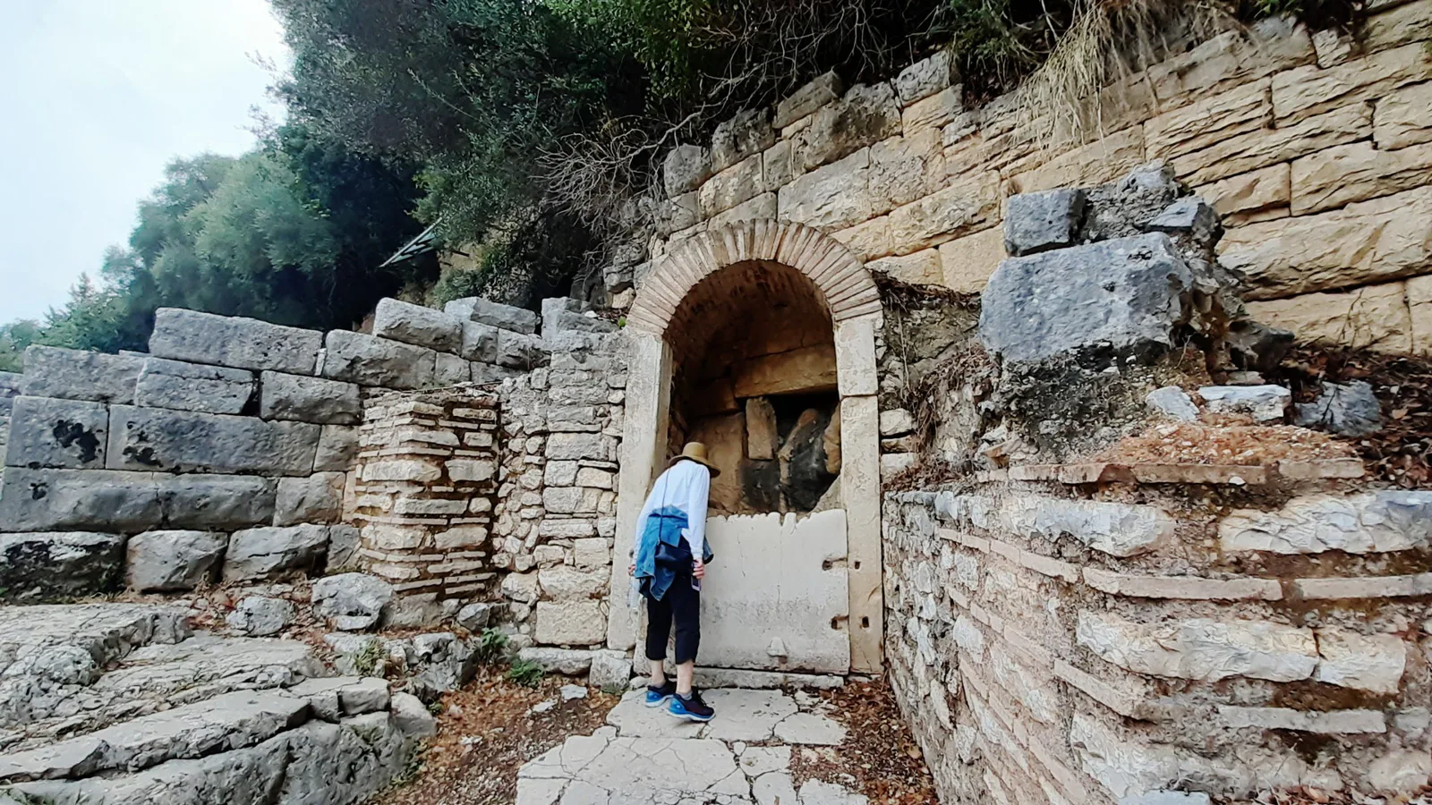 Ancient Greek and Roman ruins among trees at the Butrint archaeological site in southern Albania