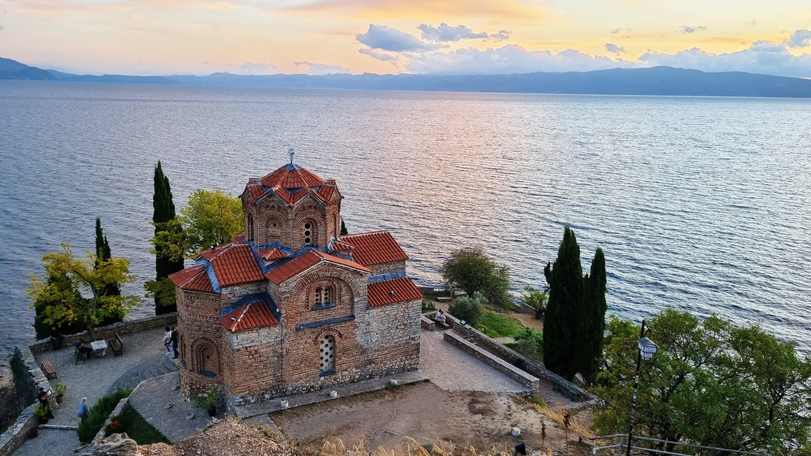 A medieval Orthodox church on a cliff above the shore of Lake Ohrid at sunset, North Macedonia