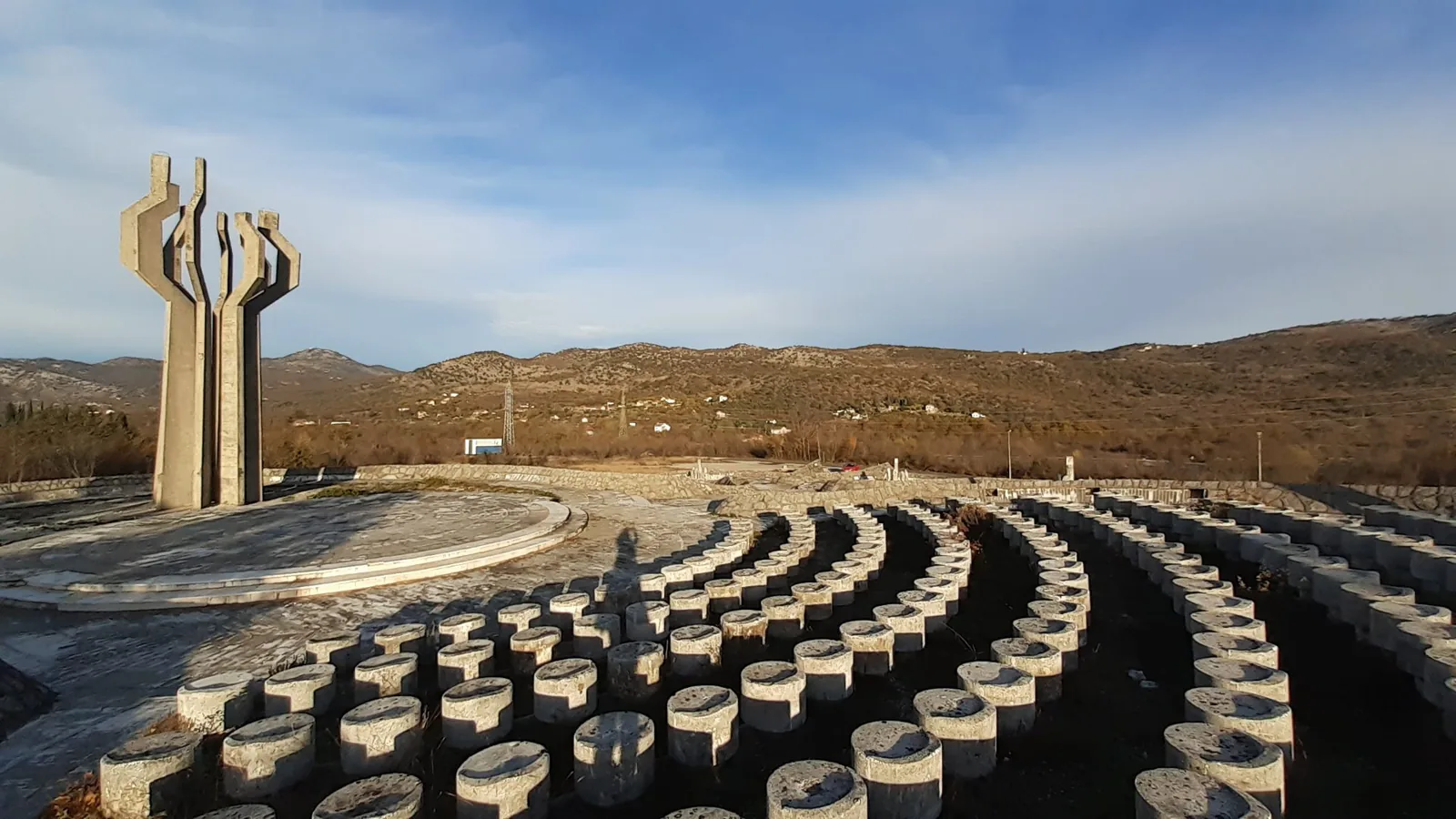 A Yugoslav-era concrete partisan memorial standing in open countryside