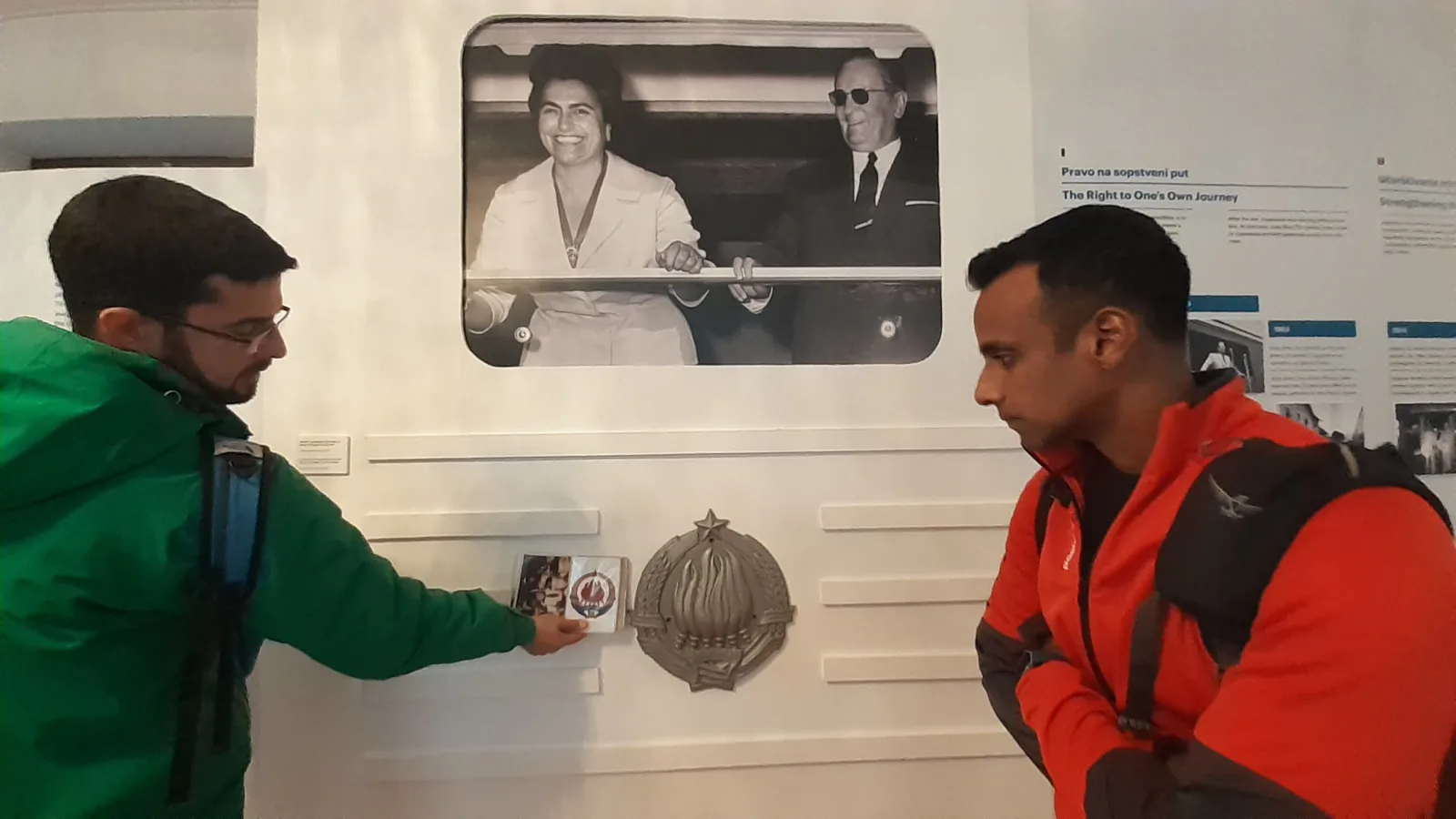 Visitors looking at an archive photograph of Tito on display in the Museum of Yugoslavia in Belgrade