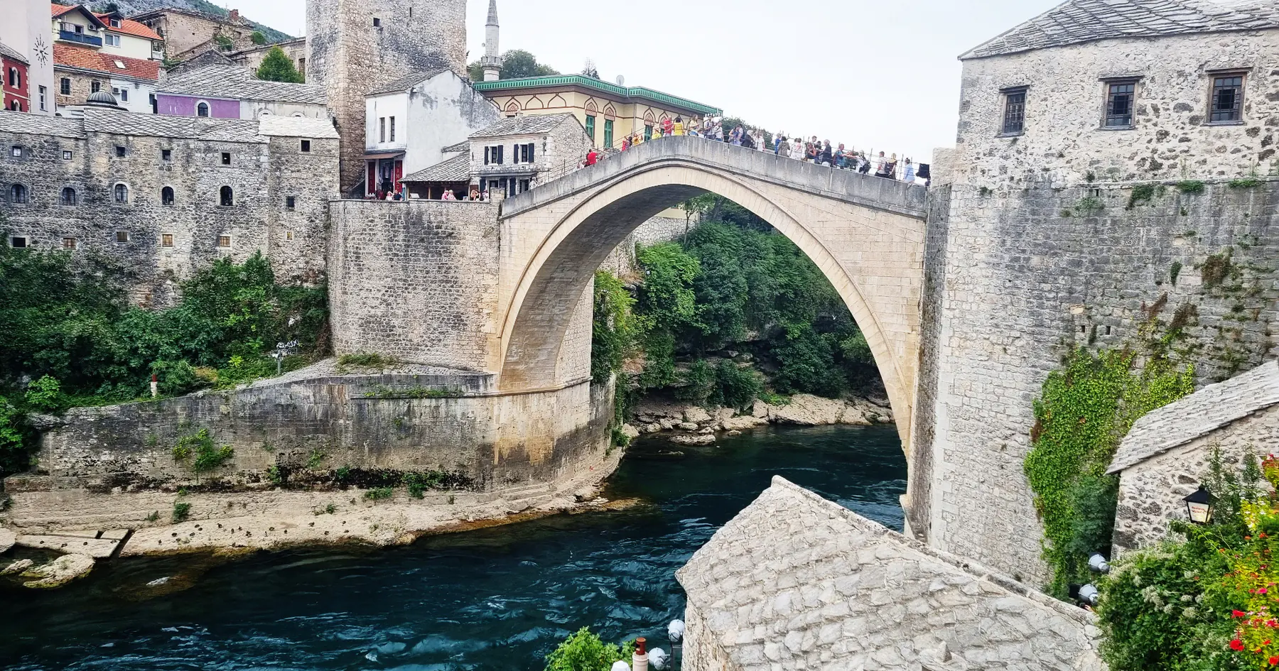 The Old Bridge of Mostar arching over the turquoise Neretva river in Bosnia & Herzegovina