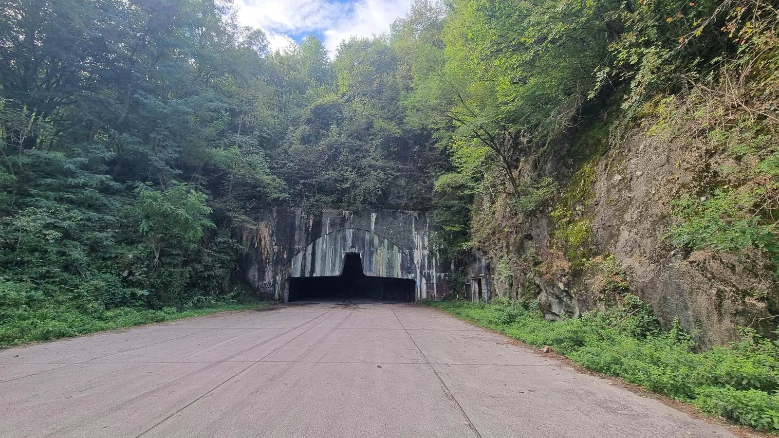 The overgrown tunnel entrance of the abandoned Željava underground airbase
